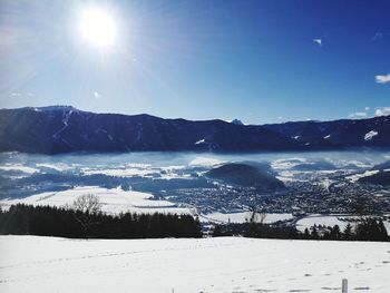 Scenic view of frozen mountains against sky