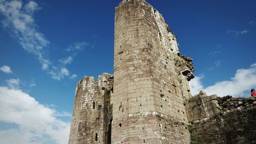 Low angle view of old building against blue sky