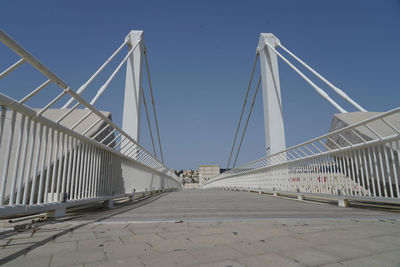 View of suspension bridge against clear blue sky
