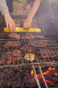 Man preparing food on barbecue grill