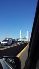 Cars on road against clear sky