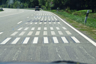 Surface level of road against trees in city