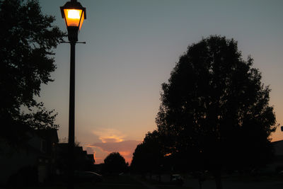 Low angle view of street light against sky at sunset