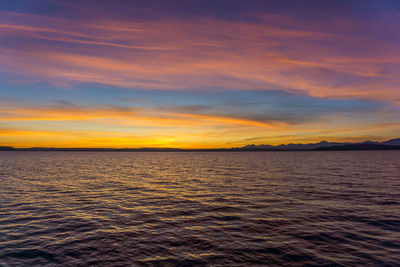 Many colors fill the sky as the sun set over the puget sound.