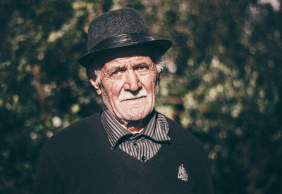 Portrait of senior man wearing hat outdoors