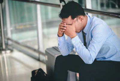 Businessman sitting on luggage