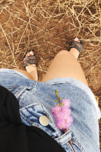 Low section of woman sitting outdoors