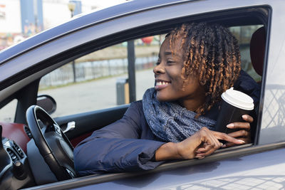 Portrait of woman sitting in car