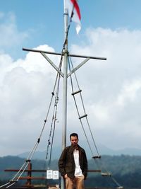 Portrait of young man on boat against sky