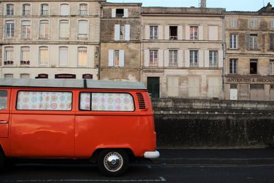Red van on road against building