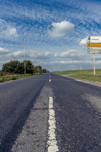 Surface level of road sign against sky