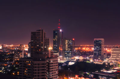 Illuminated cityscape against sky at night