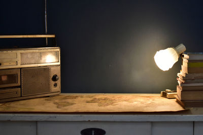 Retro workspace concept. vintage radio and cassette player, stack of books and world map