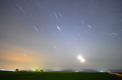 Scenic view of field against sky at night