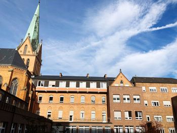 Low angle view of buildings in city against sky