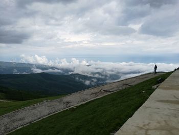 Man standing on mountain against sky