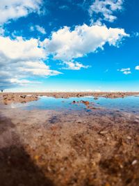 Scenic view of beach against blue sky