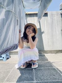 Portrait of smiling young woman sitting on staircase