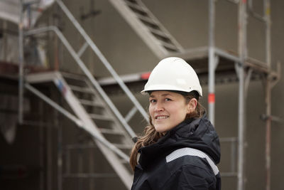 Female engineer standing at building site