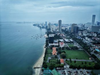 High angle view of buildings by sea against sky