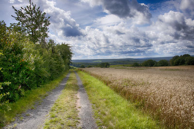 Empty road along countryside landscape