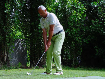 Full length of man standing on golf course