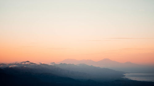 Scenic view of silhouette mountains against sky during sunset