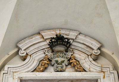 Low angle view of sculpture on wall of building