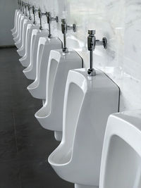 Close-up of empty urinals