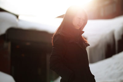 Close-up of woman standing in snow