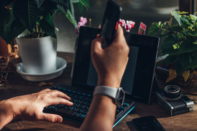 Midsection of man using laptop on table