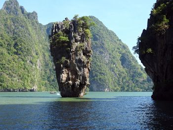 Scenic view of rock formation in sea against sky