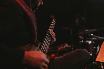 Man playing bass guitar live