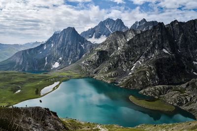 High angle view of calm lake by mountains during winter