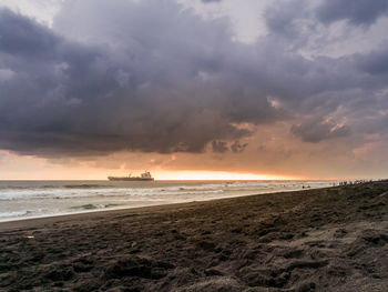 Scenic view of beach against sky during sunset