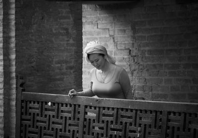 Woman wearing turban standing by railing