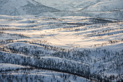 Scenic view of snow covered mountains against cloudy sky