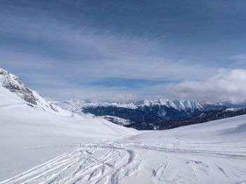 Scenic view of snowcapped mountains against sky