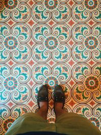 Low section of woman standing on tiled floor