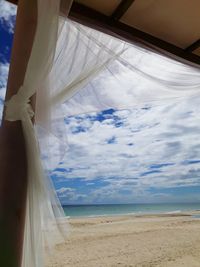 Close-up of beach against sky