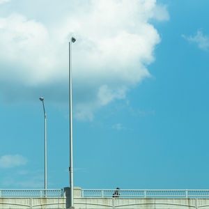 Low angle view of street lights against sky