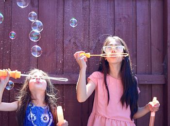 Two young girls with bubbles