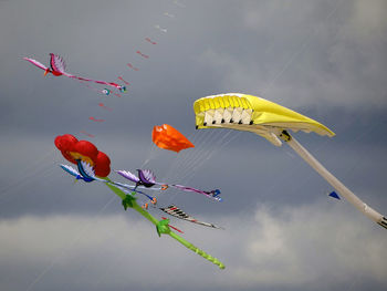 Low angle view of kites flying against sky during festival