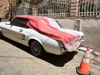 Car on road against buildings in city