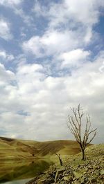 Scenic view of landscape against cloudy sky