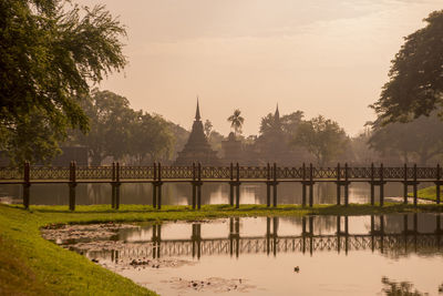 Scenic view of river against sky at sunset