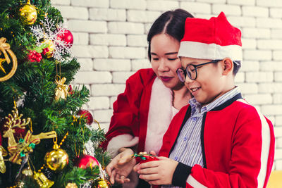 Young woman with umbrella on christmas tree