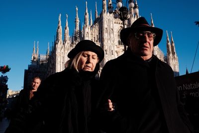 Friends in city against clear sky