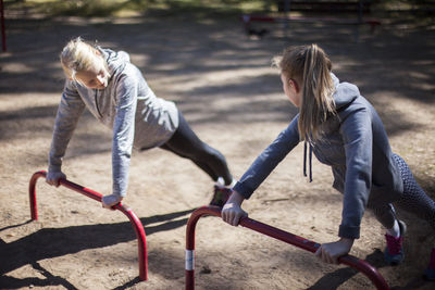 Teenage girls training on playground