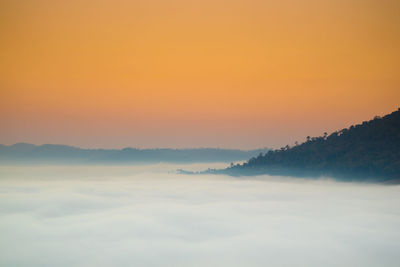 Scenic view of mountains against orange sky